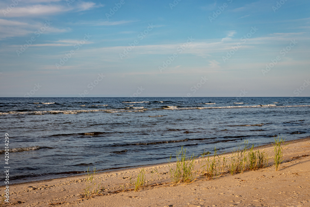Fototapeta premium beautiful miraculous seascape without people, Baltic sea Riga gulf, waves in evening sunset