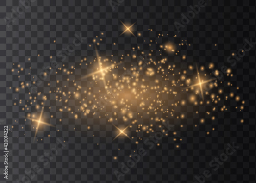 The dust sparks and golden stars shine with special light. Vector sparkles on a transparent background.
