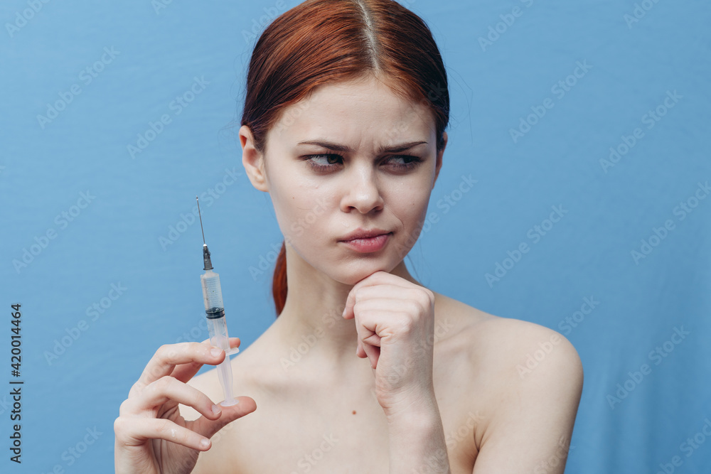 syringe in woman hand on blue background injection rejuvenation botox cropped view syringe in woman hand on blue background injection rejuvenation botox cropped view