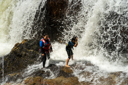 Tourist enjoys the beautiful of Lasir waterfall, Kenyir Lake, Terengganu. Lasir waterfall also known as Air Terjun Lasir.