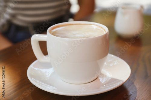 Aromatic coffee on wooden table outdoors, closeup