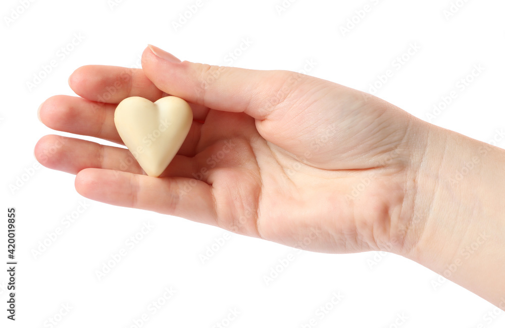 Woman holding heart shaped chocolate candy on white background, closeup Woman holding heart shaped chocolate candy on white background, closeup
