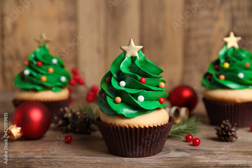 Christmas tree shaped cupcakes on wooden table