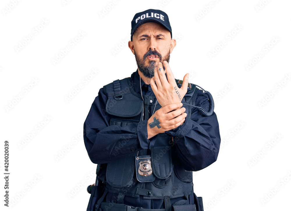 Young handsome man wearing police uniform suffering pain on hands and fingers, arthritis inflammation Young handsome man wearing police uniform suffering pain on hands and fingers, arthritis inflammation