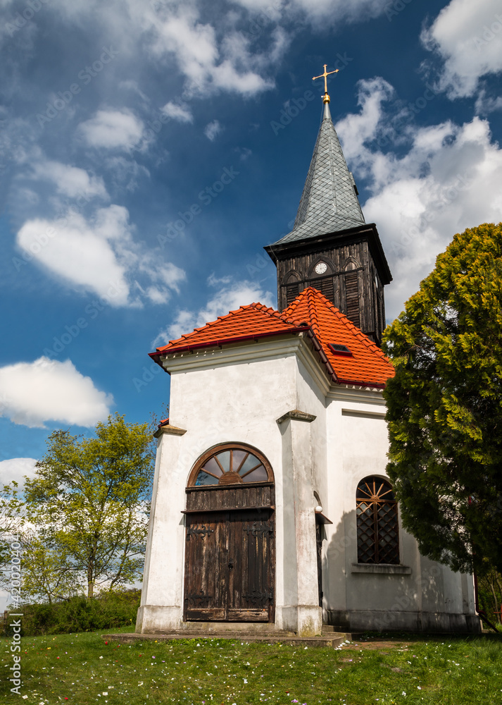 old white church with wooden door and clock tower old white church with wooden door and clock tower