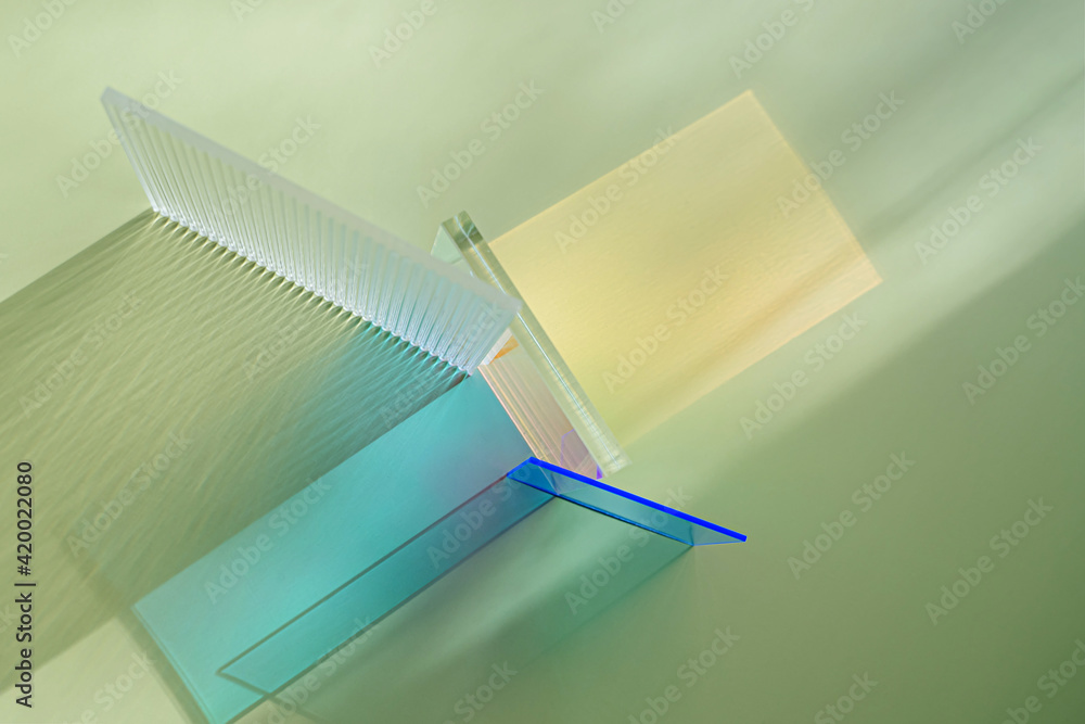 Ribbed and multicolored glass on a green background. The light travels through different acrylic sheets Ribbed and multicolored glass on a green background. The light travels through different acrylic sheets