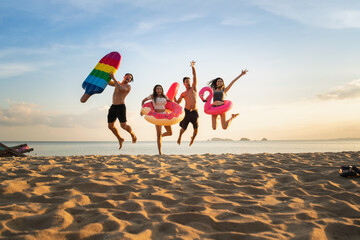  Holiday summer party with friends on the beach .Group of family and friends  jumping on the beach. lifestyle people vacation holiday on beach