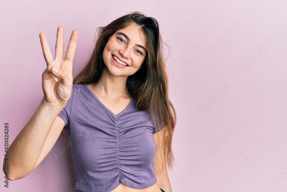 Young caucasian woman wearing casual clothes showing and pointing up with fingers number three while smiling confident and happy. Young caucasian woman wearing casual clothes showing and pointing up with fingers number three while smiling confident and happy.
