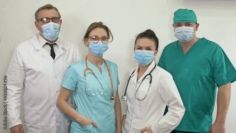 Doctors at hospital wearing medical masks to protect against coronavirus disease. Doctors at hospital wearing medical masks to protect against coronavirus disease.