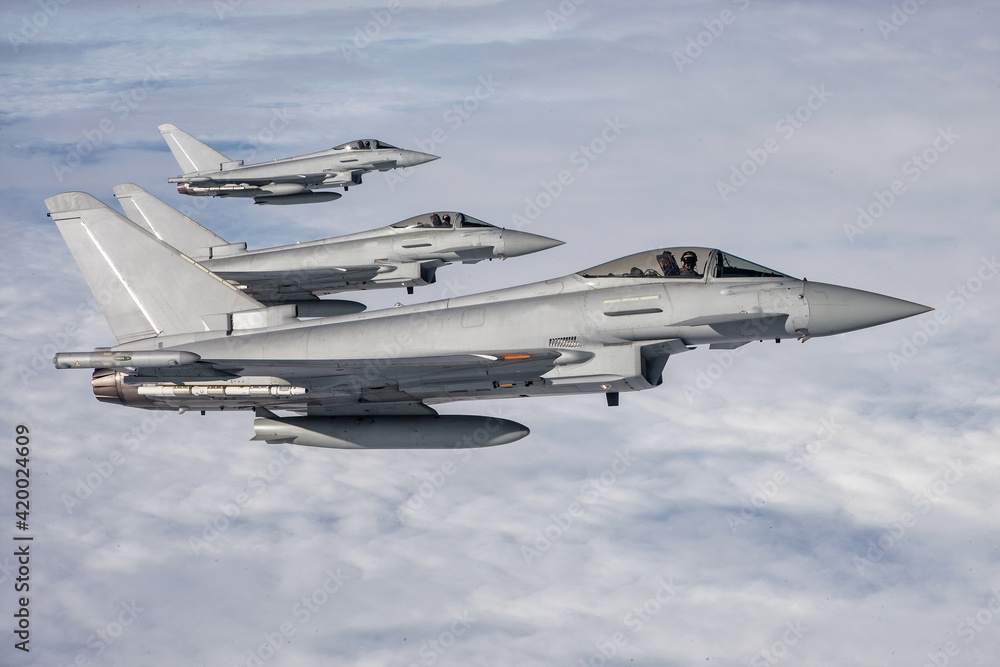RAF Typhoon Fighter Jets. Supersonic interceptors  flying in formation high above the clouds - obrazy, fototapety, plakaty 