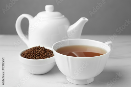 Delicious buckwheat tea and granules on white table