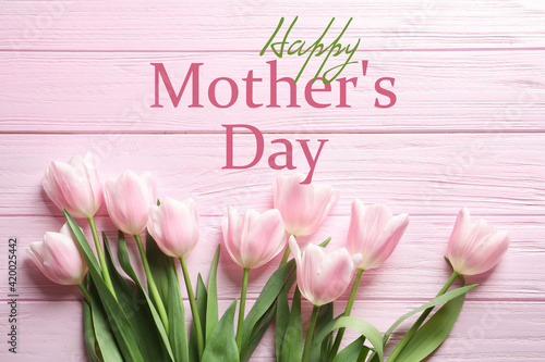 Happy Mother's Day. Beautiful tulips on pink wooden background, flat lay