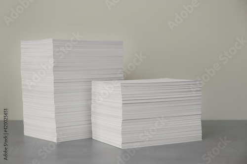 Stacks of paper sheets on grey table