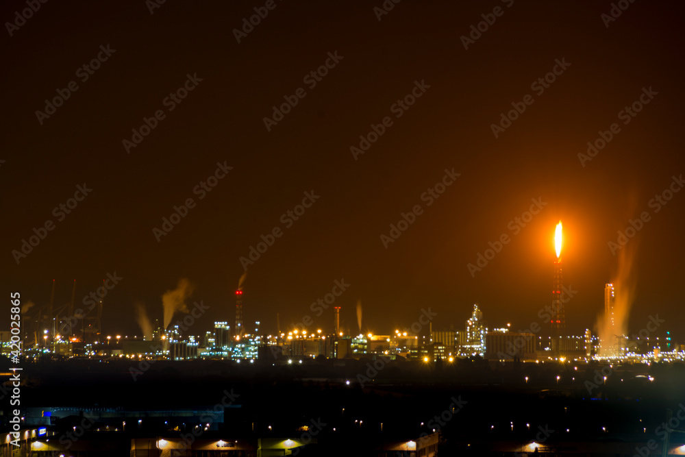 Petrochemical factory with flame at night