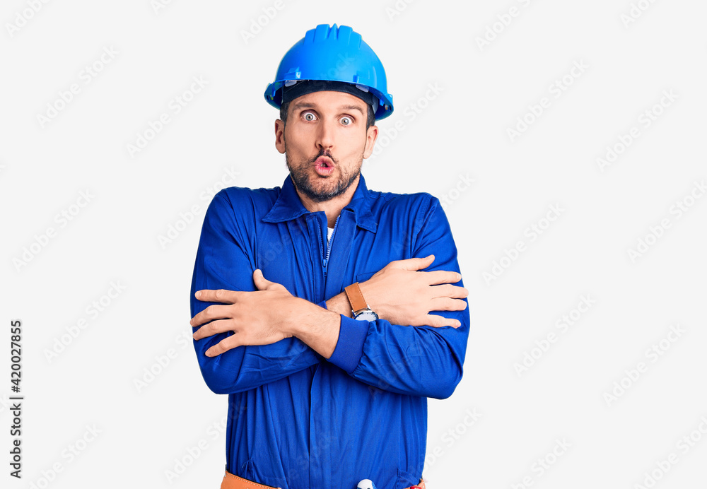 Young handsome man wearing worker uniform and hardhat pointing up looking sad and upset, indicating direction with fingers, unhappy and depressed. Young handsome man wearing worker uniform and hardhat pointing up looking sad and upset, indicating direction with fingers, unhappy and depressed.