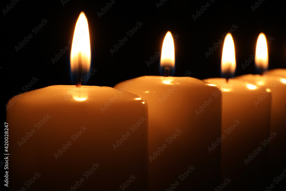 Many burning candles on black background, closeup. Memory day Many burning candles on black background, closeup. Memory day