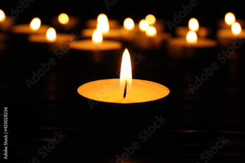 Photography Burning candle in darkness, closeup. Memory day