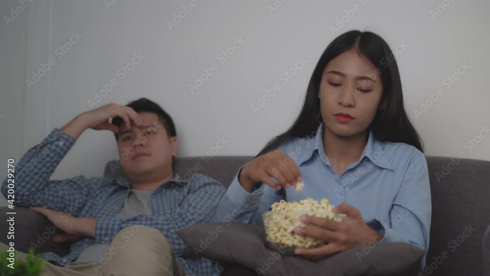 Young couple have fun watching tv together at night time.
Young couple have fun watching tv together at night time.