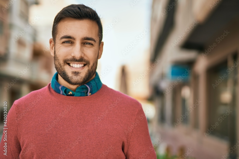 Young hispanic man smiling happy standing at the city. Young hispanic man smiling happy standing at the city.