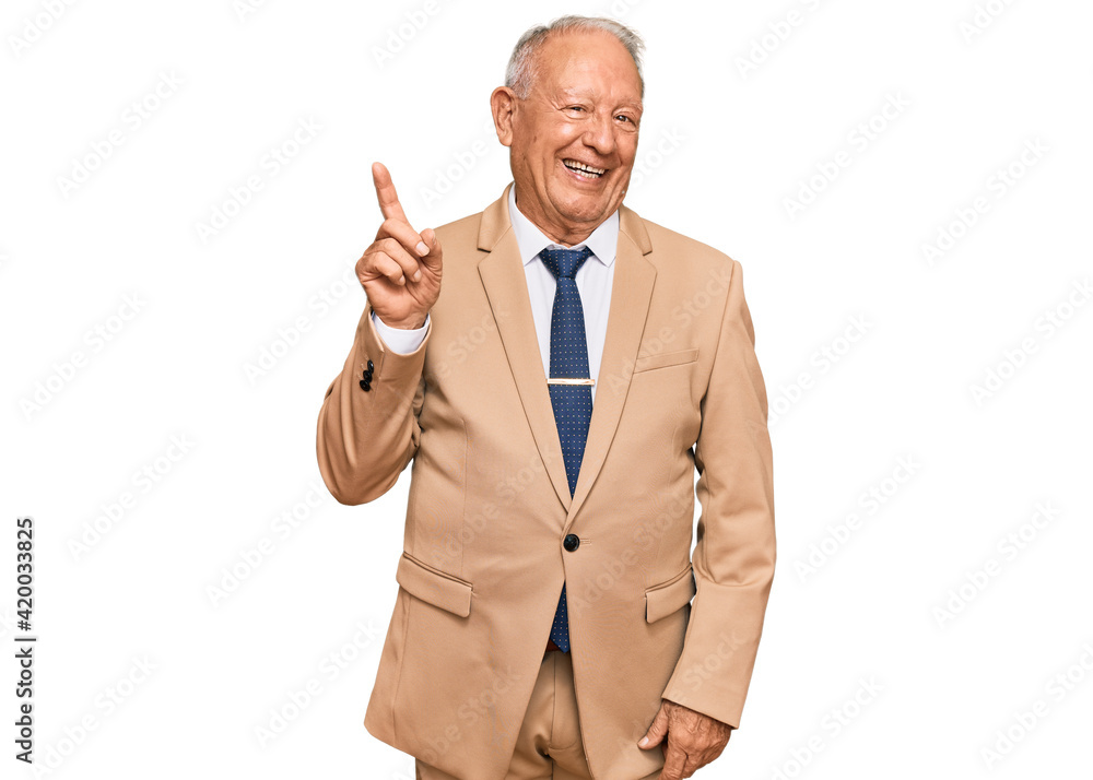 Senior caucasian man wearing business suit and tie showing and pointing up with finger number one while smiling confident and happy. Senior caucasian man wearing business suit and tie showing and pointing up with finger number one while smiling confident and happy.