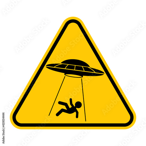 UFO abducts human from earth. Vector illustration of yellow triangle warning road sign with alien abducts man. Caution alien invasion in unidentified spaceship. Humorous traffic sign.