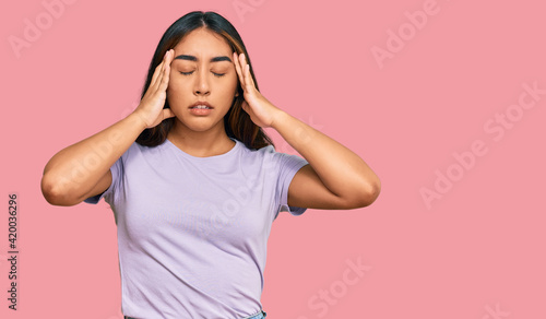 Young latin woman wearing casual clothes with hand on head for pain in head because stress. suffering migraine.