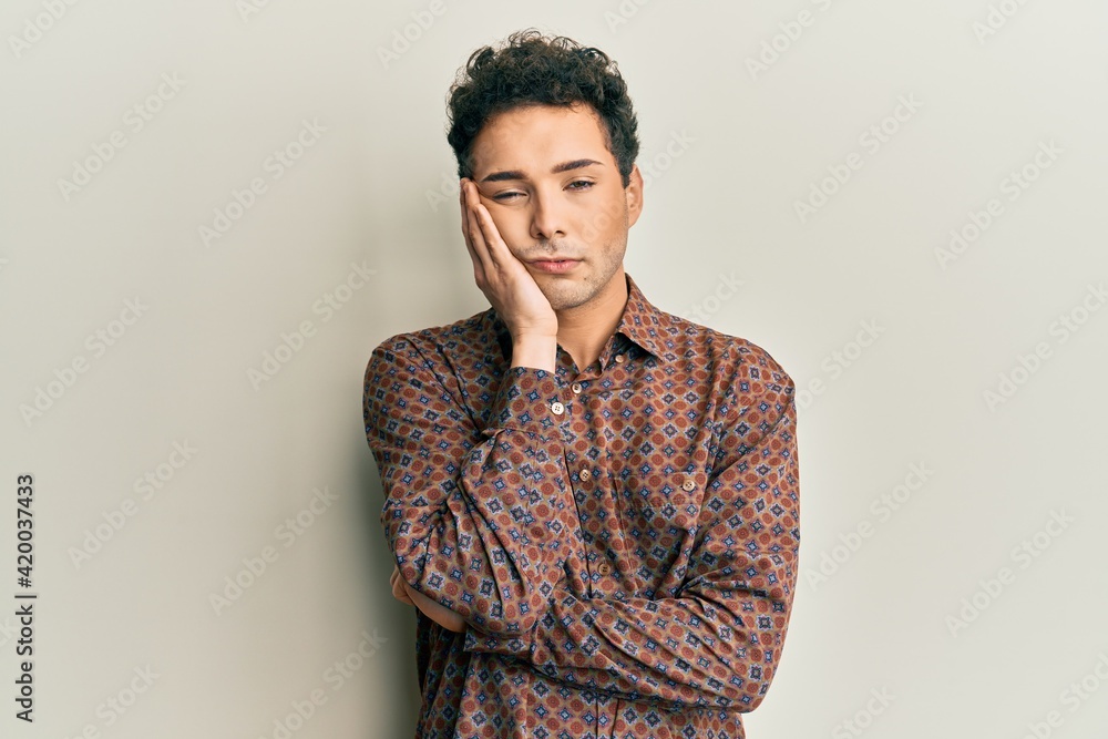Handsome hispanic man wearing casual clothes thinking looking tired and bored with depression problems with crossed arms. Handsome hispanic man wearing casual clothes thinking looking tired and bored with depression problems with crossed arms.