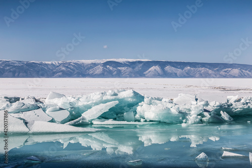 View of the frozen Lake Baikal with ice hummocks on a sunny winter day. Russia © vesta48