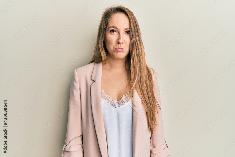 Obraz premium Young blonde woman wearing business jacket and glasses depressed and worry for distress, crying angry and afraid. sad expression.