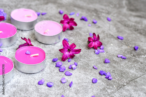SPA and wellness setting/ Natural sea salt, candles and lilac flowers. Spa products and accesories for aromatherapy