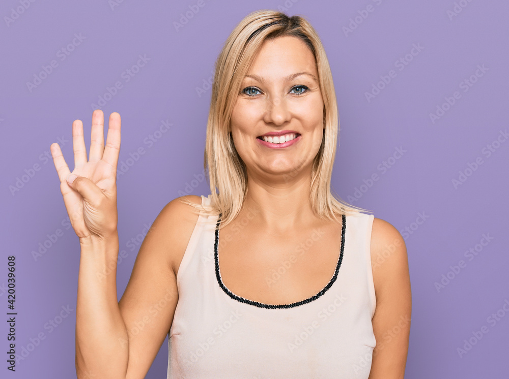 Middle age caucasian woman wearing casual clothes showing and pointing up with fingers number four while smiling confident and happy. Middle age caucasian woman wearing casual clothes showing and pointing up with fingers number four while smiling confident and happy.
