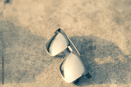Classic sunglasses model with silver lenses shoot in a summer day closeup . Selective focus. High quality photo