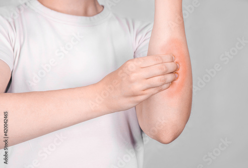 Young woman massaging her wrist after working 
