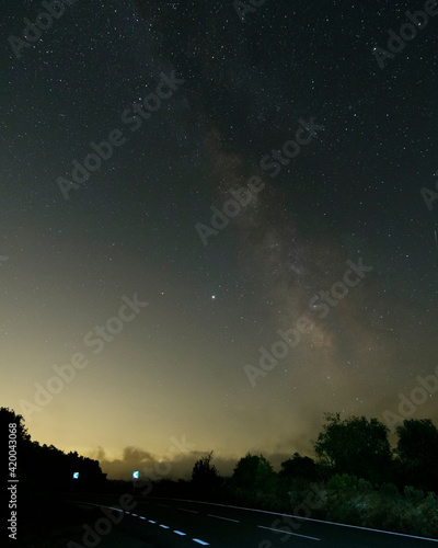 Dark road with Milky way galaxy. Night sky with stars. © Alejandro