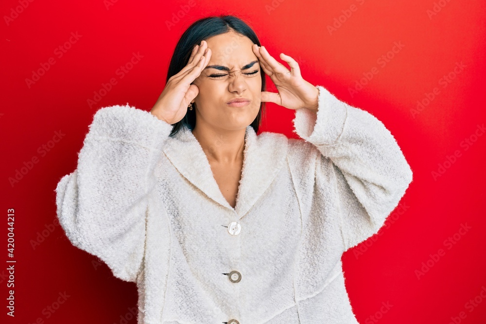 Young brunette woman wearing casual clothes with hand on head, headache because stress. suffering migraine. Young brunette woman wearing casual clothes with hand on head, headache because stress. suffering migraine.