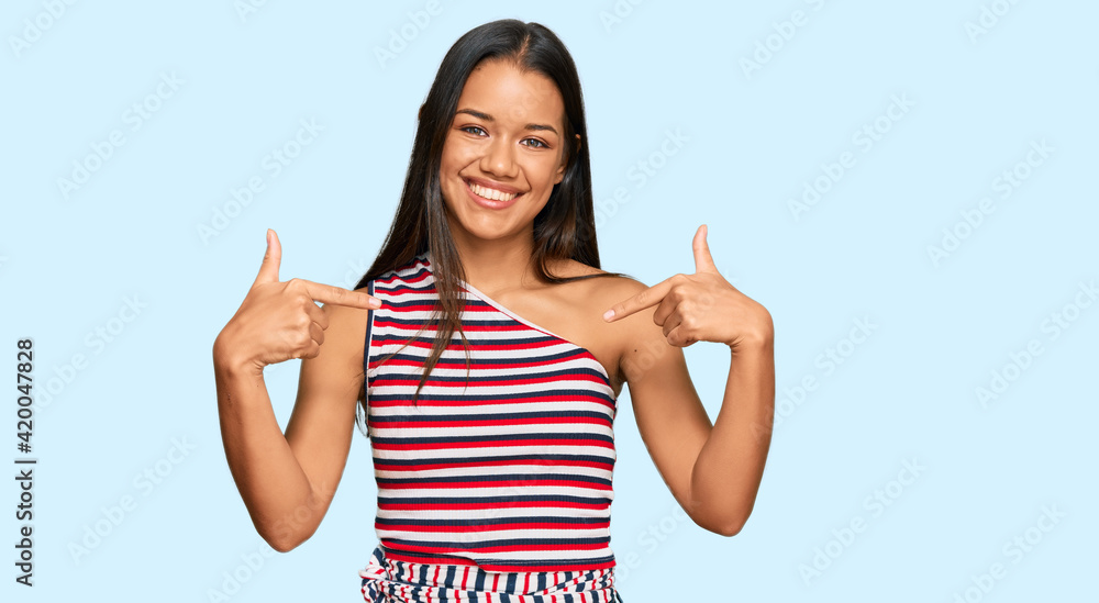 Beautiful hispanic woman wearing casual clothes looking confident with smile on face, pointing oneself with fingers proud and happy. Beautiful hispanic woman wearing casual clothes looking confident with smile on face, pointing oneself with fingers proud and happy.