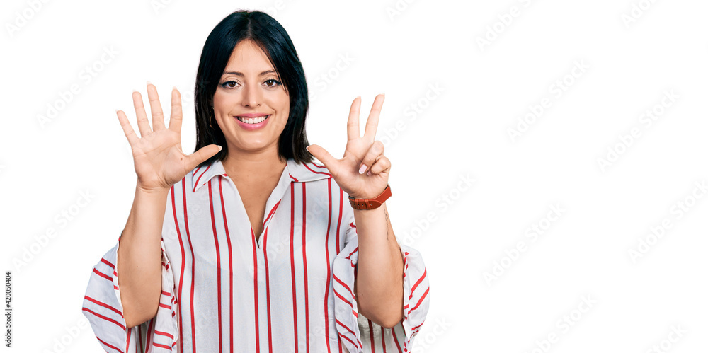 Young hispanic girl wearing casual clothes showing and pointing up with fingers number eight while smiling confident and happy. Young hispanic girl wearing casual clothes showing and pointing up with fingers number eight while smiling confident and happy.