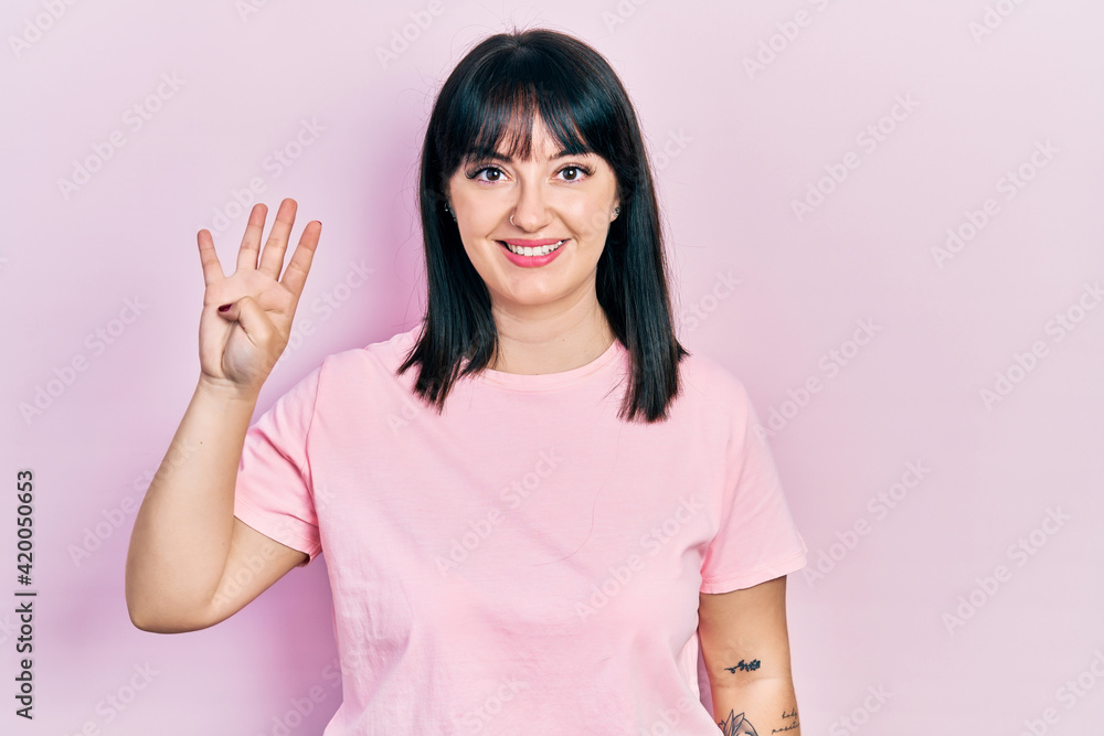 Young hispanic woman wearing casual clothes showing and pointing up with fingers number four while smiling confident and happy. Young hispanic woman wearing casual clothes showing and pointing up with fingers number four while smiling confident and happy.
