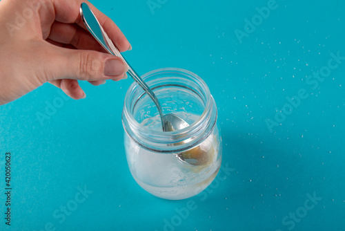 close up of honey jar on blue