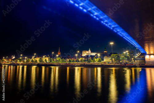 Szczecin. Night view from across the river to the illuminated historic center. Odra river. Chrobry embankments in Szczecin