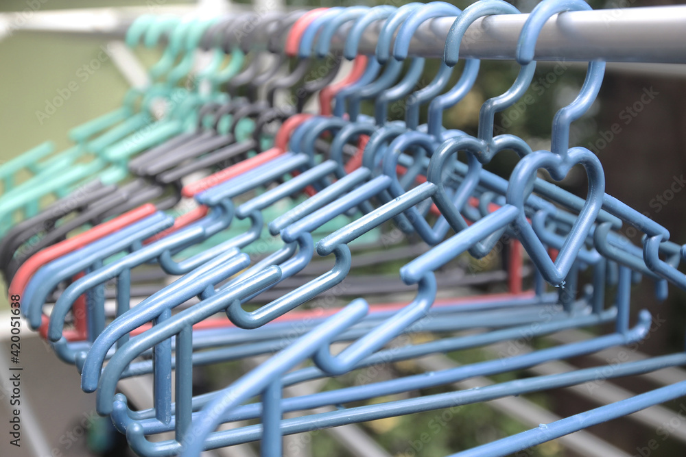 a group of clotheslines hanger hanging in the drying aluminum clothes in the yard of the house a group of clotheslines hanger hanging in the drying aluminum clothes in the yard of the house