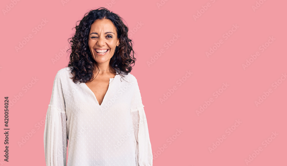 Fototapeta premium Middle age beautiful woman wearing casual sweater winking looking at the camera with sexy expression, cheerful and happy face.