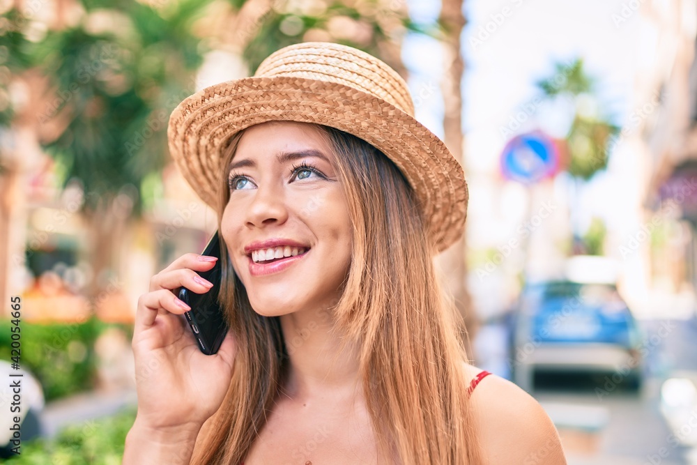 Young caucasian tourist girl smiling happy talking smartphone at the city.