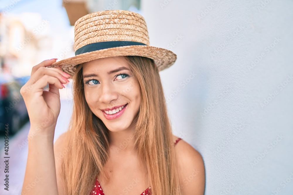 Young caucasian tourist girl smiling happy leaning on the wall at the city. Young caucasian tourist girl smiling happy leaning on the wall at the city.