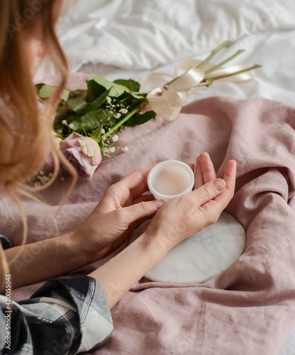 Woman with cream in her hands, mornig mood