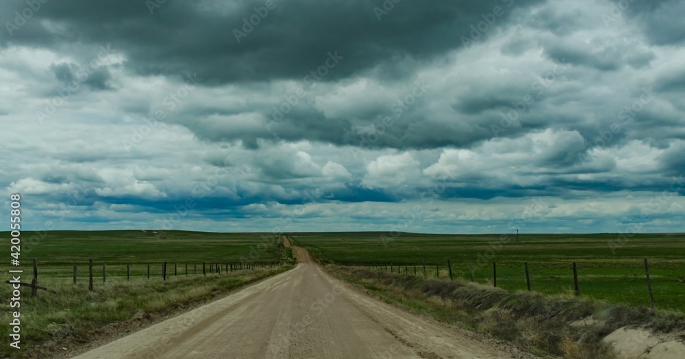 Straight dirt road stretching into the distance in spring in Nebraska, US