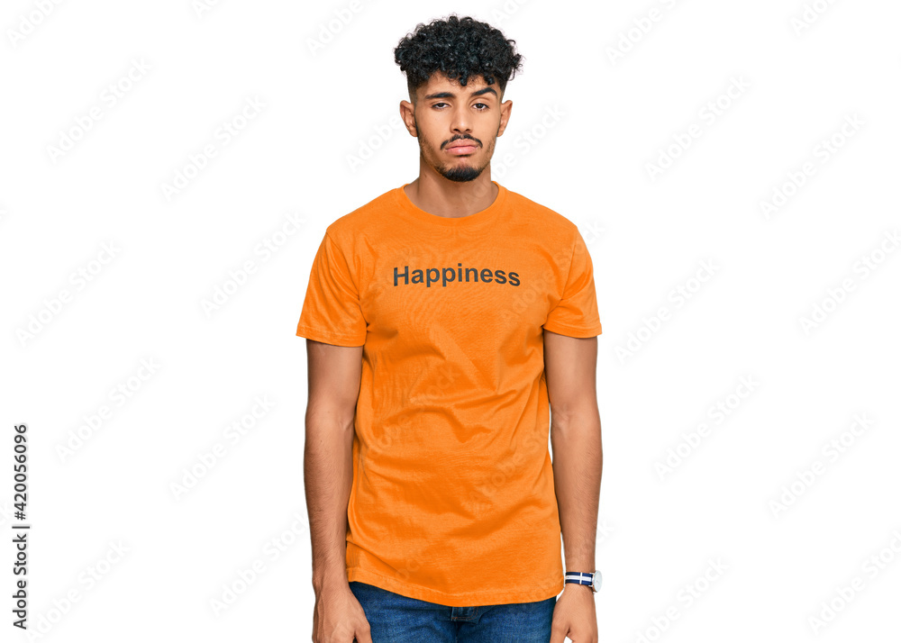 Young arab man wearing tshirt with happiness word message looking sleepy and tired, exhausted for fatigue and hangover, lazy eyes in the morning. Young arab man wearing tshirt with happiness word message looking sleepy and tired, exhausted for fatigue and hangover, lazy eyes in the morning.