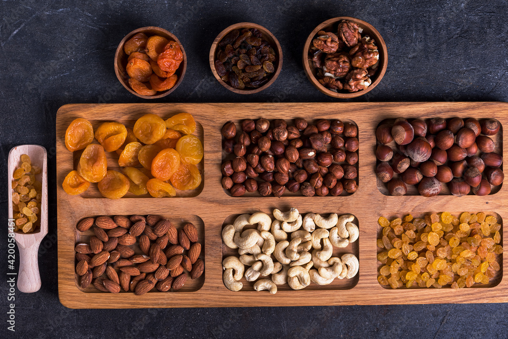 Dried fruits and nut mix on wooden board, top view. Healthy snack Dried fruits and nut mix on wooden board, top view. Healthy snack