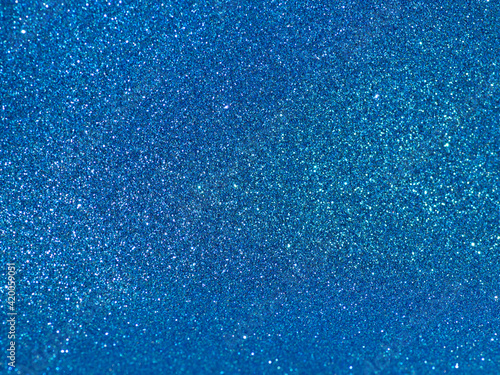 Blue background with bright sparkles. Party, celebration.