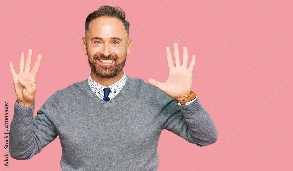 Handsome middle age man wearing business clothes showing and pointing up with fingers number nine while smiling confident and happy. Handsome middle age man wearing business clothes showing and pointing up with fingers number nine while smiling confident and happy.
